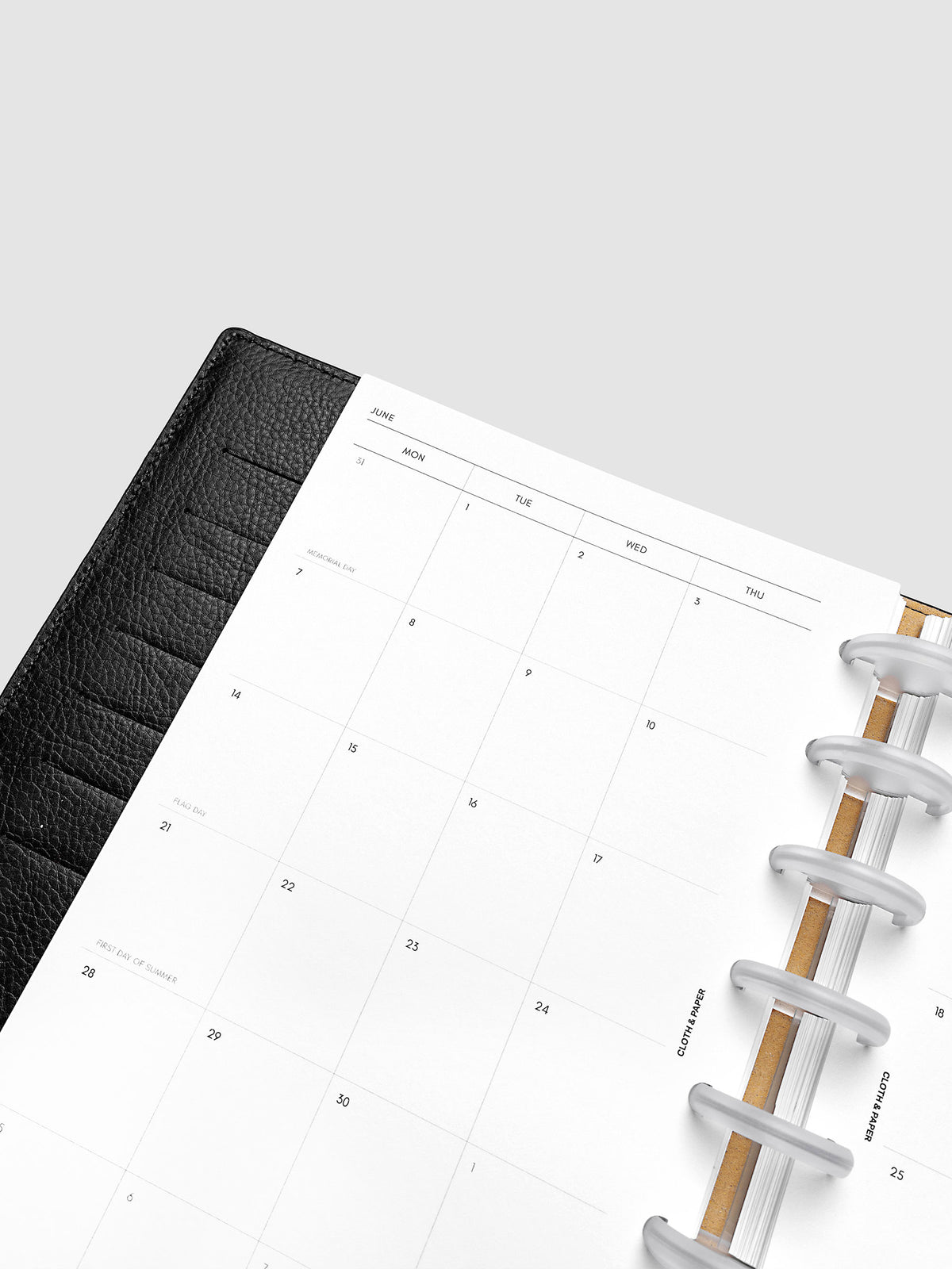 2027 Dated Monthly Planner Inserts, Monday Start, Half Letter 8-Disc Punch, close-up detail of left page monthly calendar layout with Monday start dates shown inside a planner