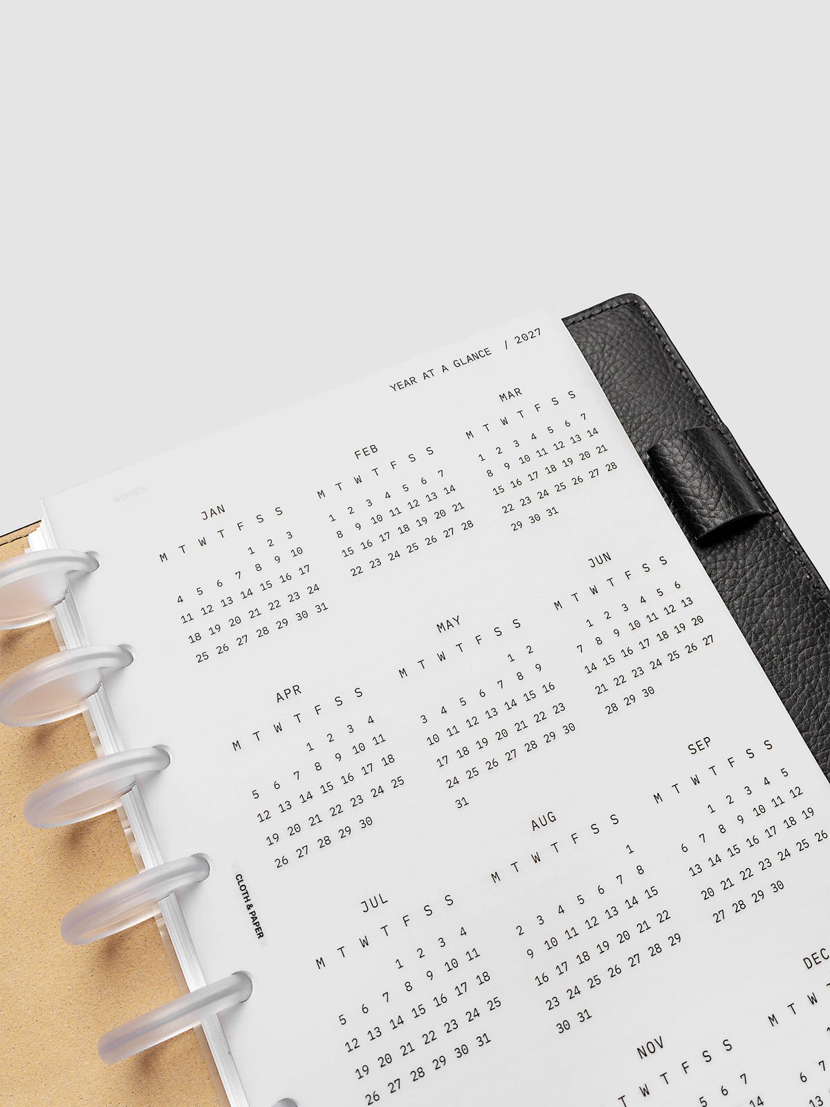 2027 Year At A Glance Dashboard Monday Start, Half Letter 8-Disc Punch, close-up of the top of the vellum dashboard showing the first months of the 2027 year-at-a-glance calendar in Monday-start format