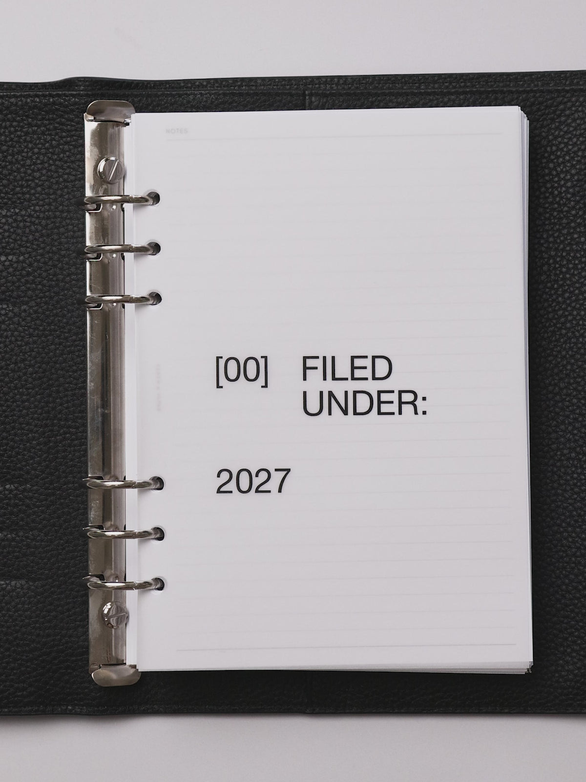 A planner flip through featuring the 2027 Front + Monthly Dashboard Overlays in the color Avant Garde
