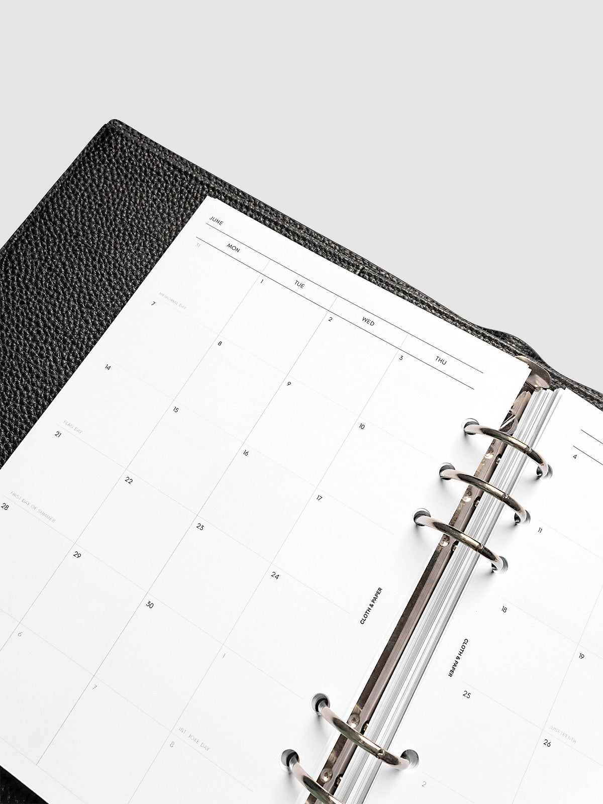 2027 Dated Monthly Planner Inserts, Monday Start, A5 6-Ring Punch, close-up detail of left page monthly calendar layout with Monday start dates shown inside a planner