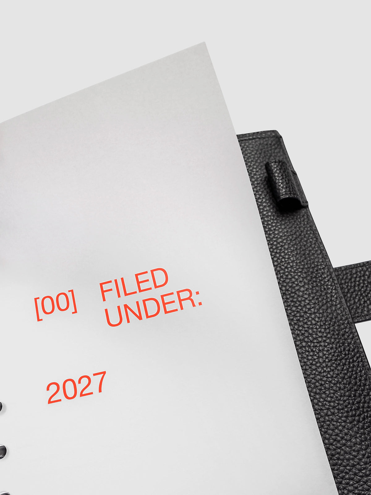 2027 Front + Monthly Dashboard Overlays, Saffron, A5 6-Ring Punch, close-up of a vellum dashboard overlay lifted to show the translucent layering effect inside a planner